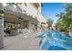 Luxury outdoor living space featuring a sparkling pool, spa, covered patio, and lush landscaping at 12125 Edgehurst Ct, Las Vegas, NV 89138