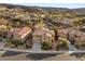 A high-angle shot of the home showing the neighborhood, landscaping and nearby mountains at 1265 Vietti St, Henderson, NV 89012