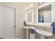 Bright bathroom featuring dual sinks, white cabinetry, and modern fixtures at 1265 Vietti St, Henderson, NV 89012