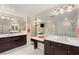 Elegant bathroom with dual sinks, dark wood cabinetry, and a large mirror at 1265 Vietti St, Henderson, NV 89012