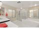 Bright bathroom featuring a soaking tub, a glass-enclosed shower, and tiled floors at 1265 Vietti St, Henderson, NV 89012