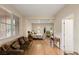 Spacious bedroom with a comfortable sofa, desk, and large windows at 1265 Vietti St, Henderson, NV 89012