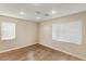Well-lit bedroom with hardwood floors and two large windows, offering a bright and airy feel at 1265 Vietti St, Henderson, NV 89012