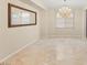 Open dining area with a chandelier and large window at 1265 Vietti St, Henderson, NV 89012