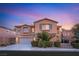 Charming two-story home with a stone facade, well-manicured landscaping, and a two-car garage at 1265 Vietti St, Henderson, NV 89012