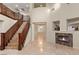 Inviting foyer features a grand staircase, soaring ceilings, fireplace, and marble floors at 1265 Vietti St, Henderson, NV 89012