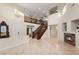 Elegant foyer features a grand staircase, soaring ceilings, fireplace, and marble floors at 1265 Vietti St, Henderson, NV 89012