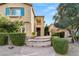 Inviting front entrance with stone steps, manicured bushes, and a covered porch at 1265 Vietti St, Henderson, NV 89012