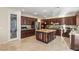 Modern kitchen with dark cabinets, stainless steel appliances, and a large island at 1265 Vietti St, Henderson, NV 89012