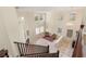 Living room with tall ceilings, a chandelier, fireplace, and staircase at 1265 Vietti St, Henderson, NV 89012