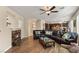 Cozy living room featuring a fireplace, dark sofa, and a view into the kitchen at 1265 Vietti St, Henderson, NV 89012