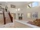 Bright living room with a staircase, fireplace, high ceilings, and several windows that provide lots of natural light at 1265 Vietti St, Henderson, NV 89012