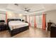 Inviting main bedroom with a tray ceiling, hardwood floors, and large windows at 1265 Vietti St, Henderson, NV 89012