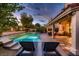 Relaxing backyard with pool, hot tub, and covered patio, perfect for outdoor living at 13 Cozy Glen Cir, Henderson, NV 89074