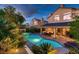 Backyard featuring a sparkling pool, spa, covered patio with comfortable seating, and mature landscaping at 13 Cozy Glen Cir, Henderson, NV 89074