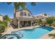 Backyard with pool and covered patio, offers a peaceful retreat for relaxation and outdoor enjoyment at 13 Cozy Glen Cir, Henderson, NV 89074