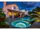 Backyard view showcasing the pool, spa, covered patio, and lush landscaping, perfect for outdoor enjoyment at 13 Cozy Glen Cir, Henderson, NV 89074