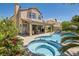 Backyard featuring a refreshing pool, spa, covered patio, and landscaped yard, creating a private oasis at 13 Cozy Glen Cir, Henderson, NV 89074