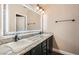 Bathroom featuring a granite vanity, two sinks, and an illuminated mirror at 13 Cozy Glen Cir, Henderson, NV 89074