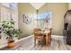 Bright dining area featuring large windows, plantation shutters, and elegant chandelier at 13 Cozy Glen Cir, Henderson, NV 89074