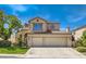 Charming two-story home featuring a three-car garage and well-maintained landscaping at 13 Cozy Glen Cir, Henderson, NV 89074