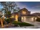 Charming two-story home with manicured lawn, mature trees, and a welcoming double-door entrance at 13 Cozy Glen Cir, Henderson, NV 89074