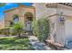 Landscaped front yard with a tiled walkway leading to the front door and an attached three-car garage at 13 Cozy Glen Cir, Henderson, NV 89074