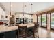 Modern kitchen with granite countertops, an island with seating, and stainless steel appliances at 13 Cozy Glen Cir, Henderson, NV 89074