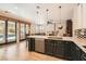 Open kitchen with granite countertops, an island with seating, and views of the backyard pool at 13 Cozy Glen Cir, Henderson, NV 89074