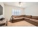 Living room featuring a sectional sofa, a large window and carpeted floors at 13 Cozy Glen Cir, Henderson, NV 89074