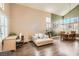 Open-concept living room with vaulted ceilings, large windows, and stylish wood-look flooring at 13 Cozy Glen Cir, Henderson, NV 89074