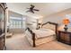Spacious main bedroom with a fireplace, ceiling fan and large windows offering natural light at 13 Cozy Glen Cir, Henderson, NV 89074