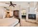 View of main bedroom showcasing an en-suite bathroom, fireplace, and plush carpet at 13 Cozy Glen Cir, Henderson, NV 89074