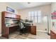 Home office with custom desk, ample storage, and natural light at 13 Cozy Glen Cir, Henderson, NV 89074