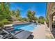 Inviting pool and spa area with mature trees and seating; ideal for entertaining at 13 Cozy Glen Cir, Henderson, NV 89074