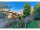 Landscaped backyard featuring an outdoor sitting area with views of an elegant water fountain at 17 Chatmoss Rd, Henderson, NV 89052