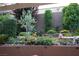 Beautifully landscaped backyard with mature trees, a tiered garden with vibrant flowers, and stone accents at 17 Chatmoss Rd, Henderson, NV 89052