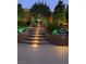 An eye-catching backyard with a water fountain, rock accents, garden, and stair lights at 17 Chatmoss Rd, Henderson, NV 89052