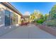 The backyard patio features outdoor seating and lush greenery at 17 Chatmoss Rd, Henderson, NV 89052