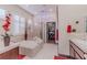 Well-lit bathroom with a soaking tub, glass-enclosed shower, and modern fixtures at 17 Chatmoss Rd, Henderson, NV 89052