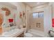 Cozy bathroom with a shower-tub combo, neutral tile, and decorative wall accents at 17 Chatmoss Rd, Henderson, NV 89052