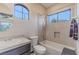 Well-lit bathroom with a tub-shower combination, a dark vanity, and a built-in toiletry nook at 17 Chatmoss Rd, Henderson, NV 89052