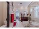 Bathroom with a soaking tub, vanity, decorative mirrors, and access to the bedroom at 17 Chatmoss Rd, Henderson, NV 89052