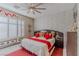 Airy bedroom featuring bright accents, textured wall, plantation shutters, and contemporary decor at 17 Chatmoss Rd, Henderson, NV 89052
