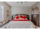 Bright bedroom with a textured feature wall, ceiling fan, and a well-lit space at 17 Chatmoss Rd, Henderson, NV 89052