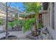 Scenic courtyard view with a pergola, decorative hanging decor, plants and custom hardscape at 17 Chatmoss Rd, Henderson, NV 89052