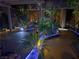 Night view of a cozy courtyard featuring decorative lighting, plants, pavers and outdoor decor at 17 Chatmoss Rd, Henderson, NV 89052