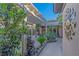 Picturesque courtyard featuring a pergola, lush greenery, stone accents, and decorative art at 17 Chatmoss Rd, Henderson, NV 89052