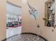 Elegant entryway showcasing a decorative mosaic floor, modern lighting, and artistic wall accents at 17 Chatmoss Rd, Henderson, NV 89052