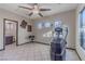 Bright exercise room featuring tile flooring, ample natural light, and workout equipment at 17 Chatmoss Rd, Henderson, NV 89052